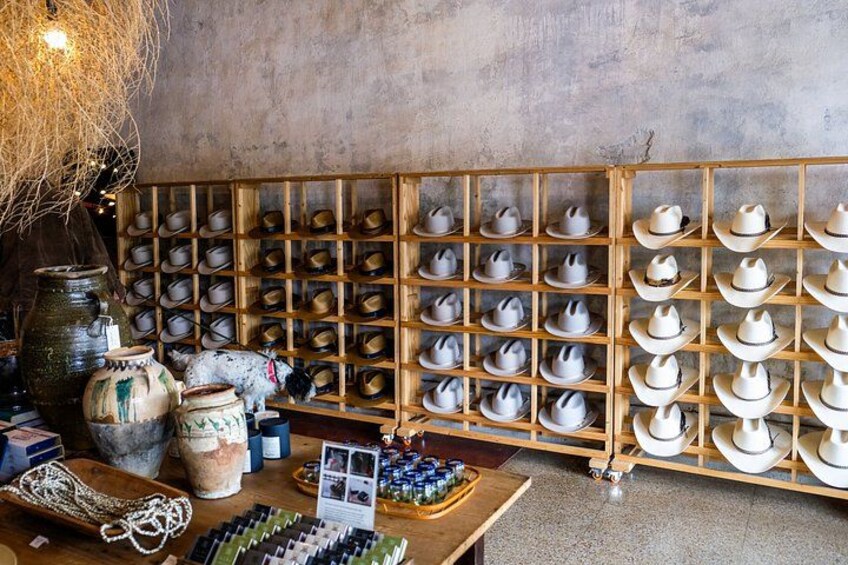 A store with shelves of hats and pottery. 5