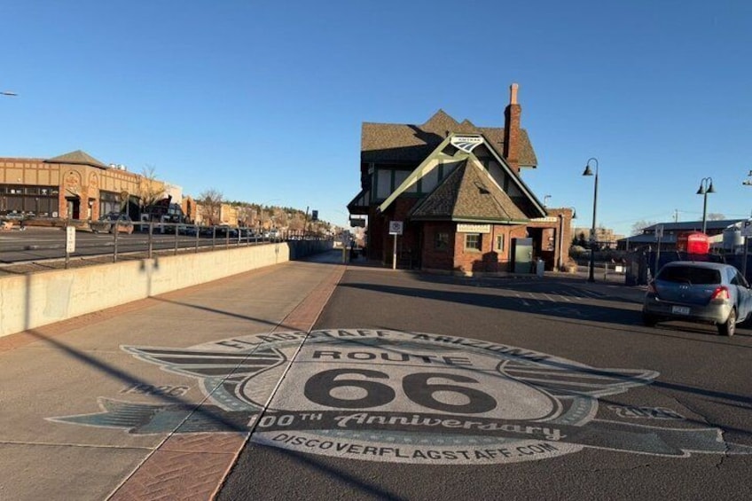 A road sign for Route 66 with a 100th anniversary celebration. 4