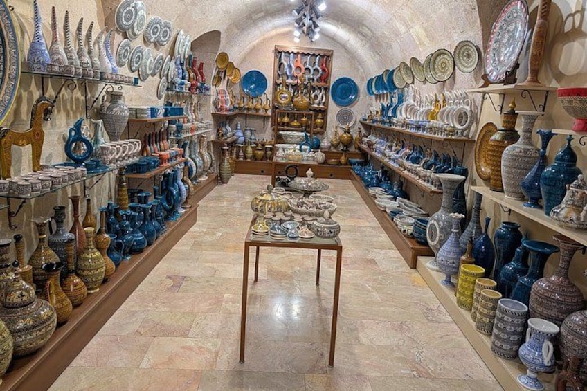 A pottery shop with shelves of colorful ceramic items. 1