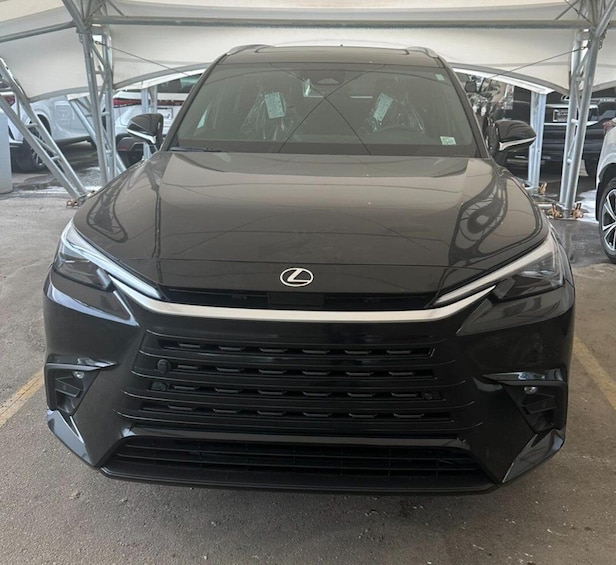 A black Lexus SUV parked under a tent. 3