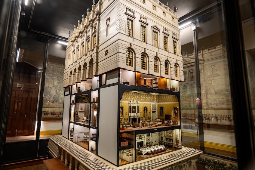 A detailed scale model of a historic building with multiple floors, large windows, and ornate architectural details. 3