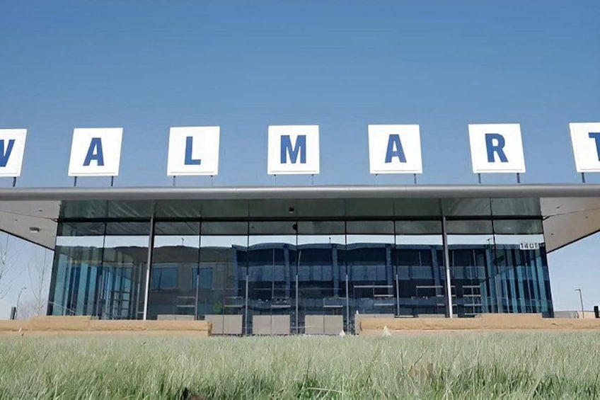 A Walmart store with a modern glass facade and the store's name displayed above. 2