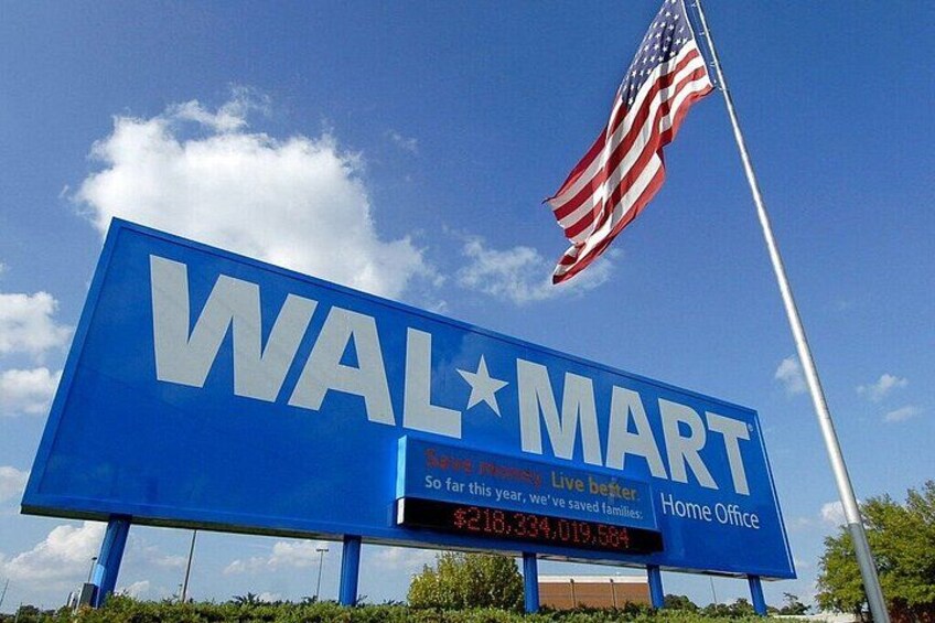 A large blue billboard with the Walmart logo and an American flag. 4