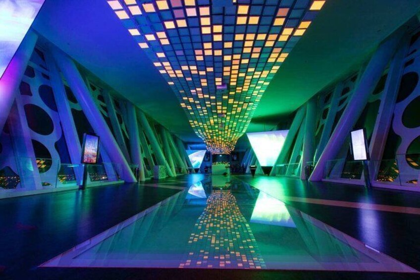 A futuristic interior with geometric patterns and illuminated panels. 3