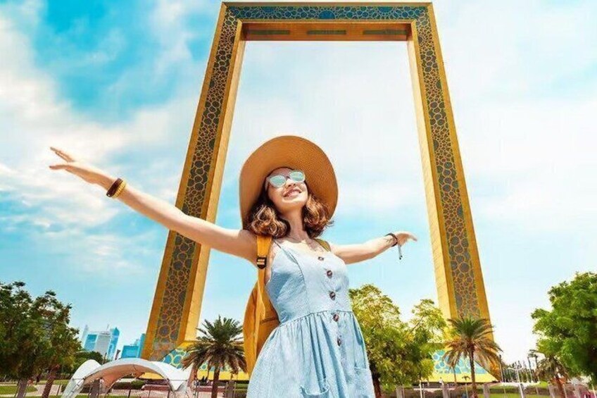 A person standing in front of a large, ornate archway with a cityscape in the background. 1