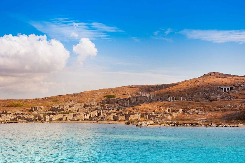 A coastal archaeological site with ruins and a clear blue sky. 5