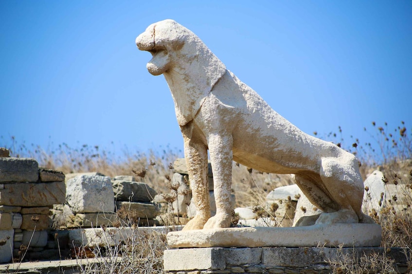 A stone statue of a lion in a historical site. 2