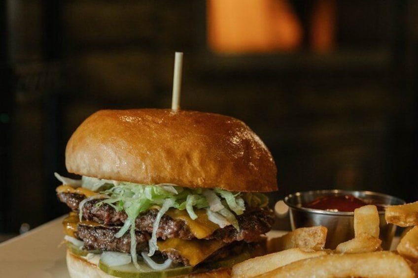 A burger with fries and ketchup. 2
