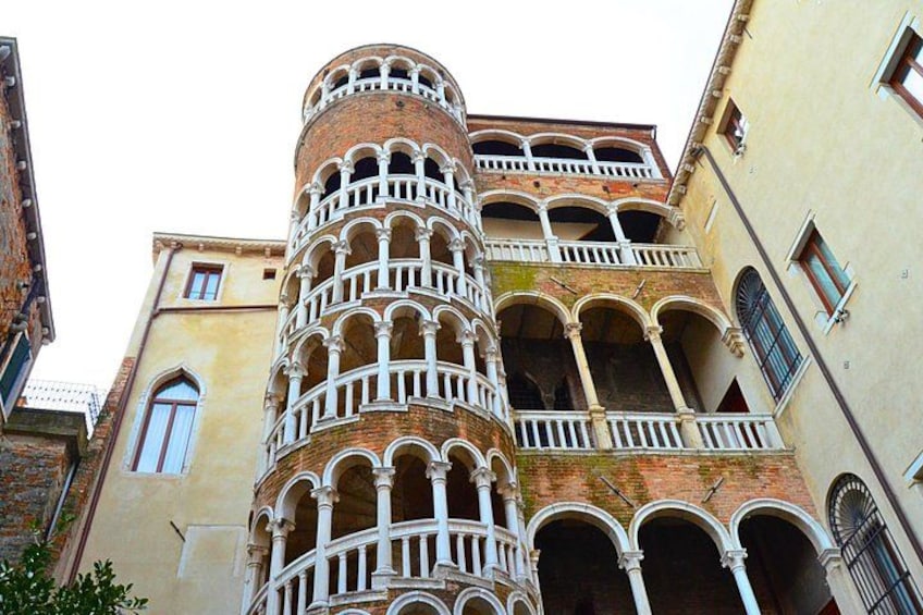 A historic building with a cylindrical tower and multiple balconies. 4