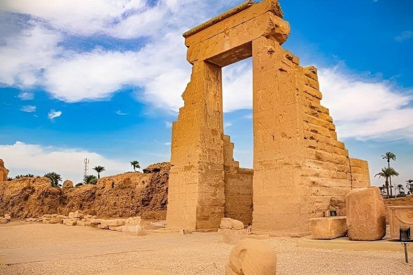 An ancient Egyptian temple with a large stone archway. 3
