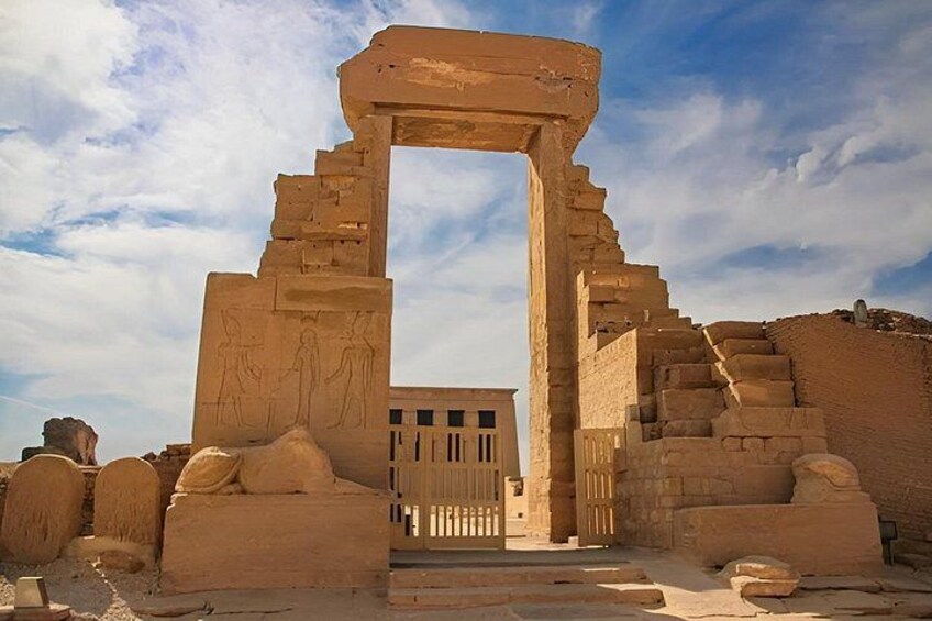 Ancient Egyptian ruins with a large stone archway and hieroglyphics. 2