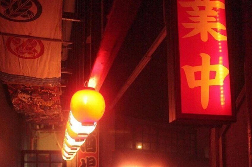 A traditional Chinese lantern with a red sign in the background. 2