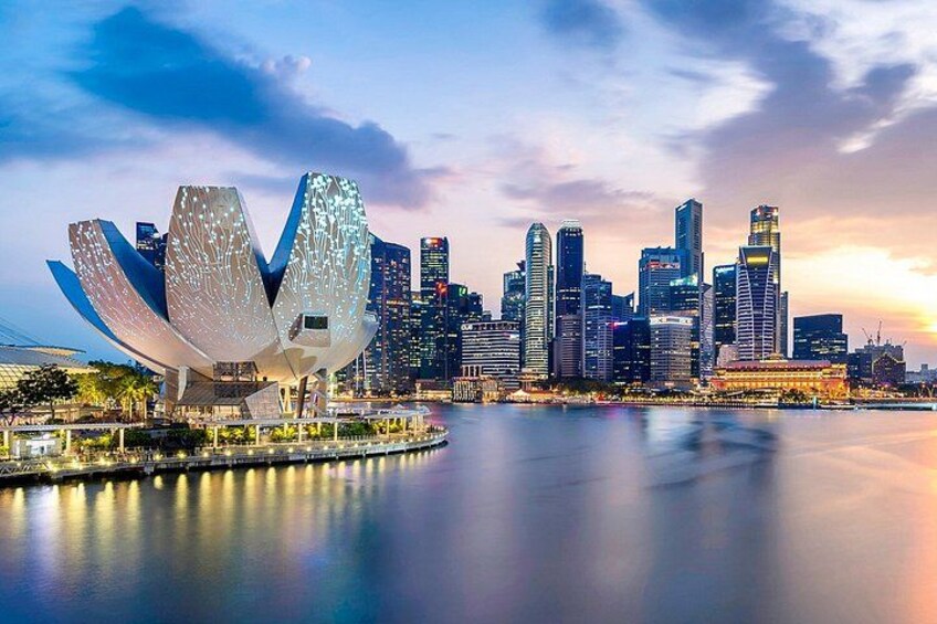 A city skyline with modern architecture, including a distinctive building with a unique design. 4