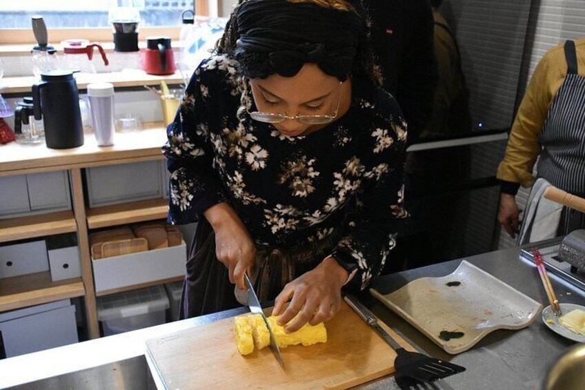 A person slicing yellow fruit on a cutting board in a kitchen. 3