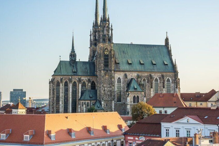 A historic church with a tall spire and a clock tower. 5