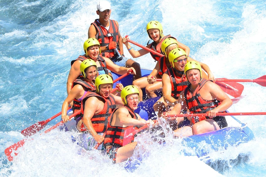 A group of people in a raft navigating through a body of water. 3