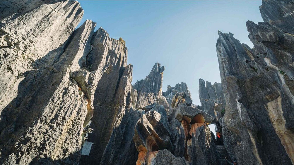 A rugged canyon landscape with towering rock formations and a narrow pathway. 5