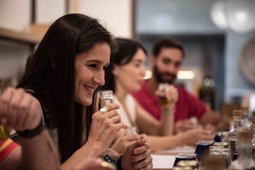 A group of people sitting at a table, holding glasses, likely in a social setting. 2