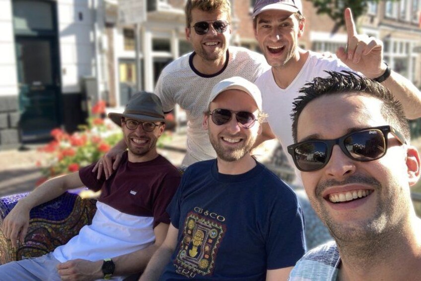 A group of people sitting on a bench outdoors. 3