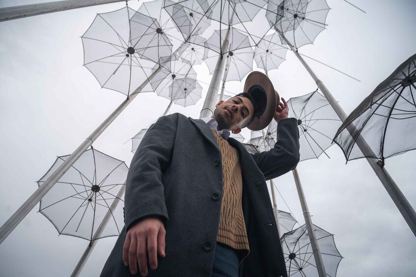 A person standing under a canopy of umbrellas. 1