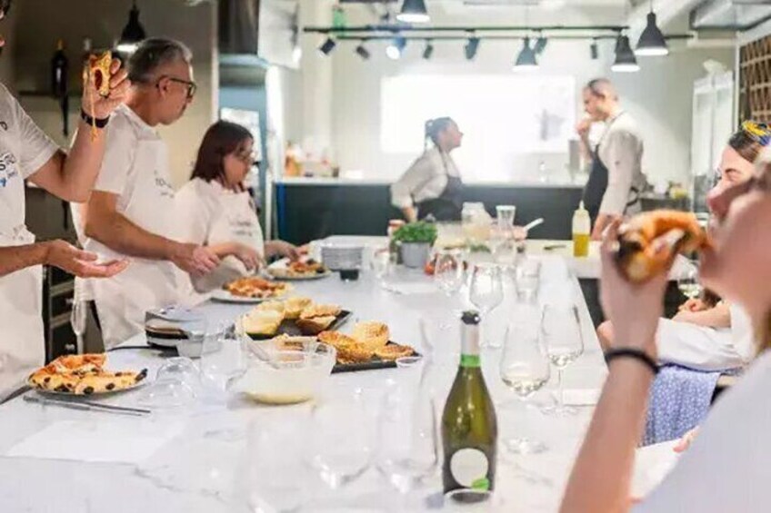 A group of people dining at a restaurant with a table set for a meal. 5