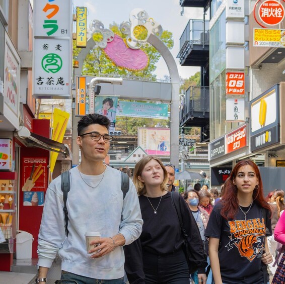 A busy urban street with various shops and signs, including a Thai restaurant and a coffee shop. 3