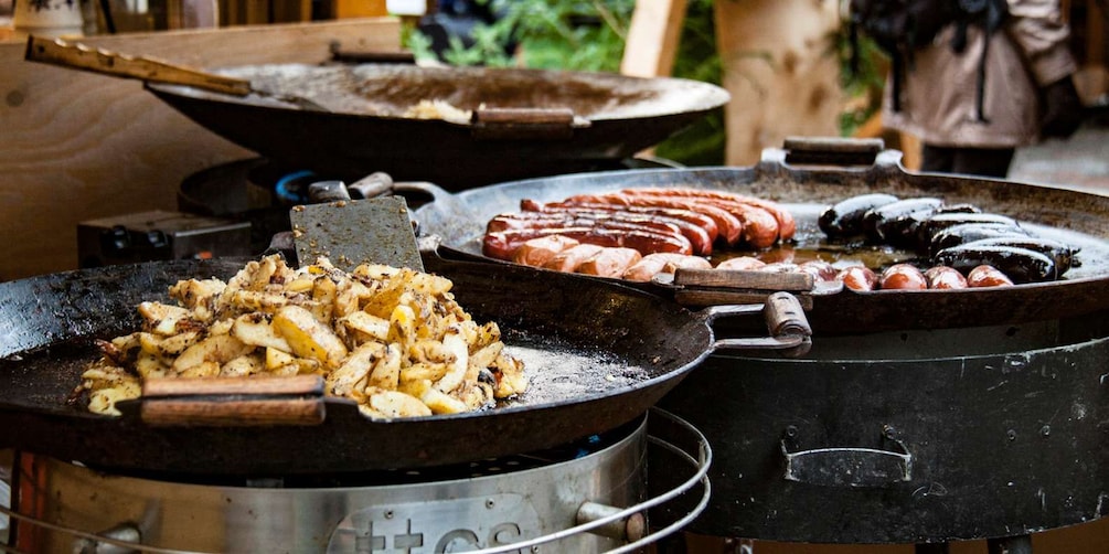 A cooking area with a grill, a frying pan, and a pot. 2