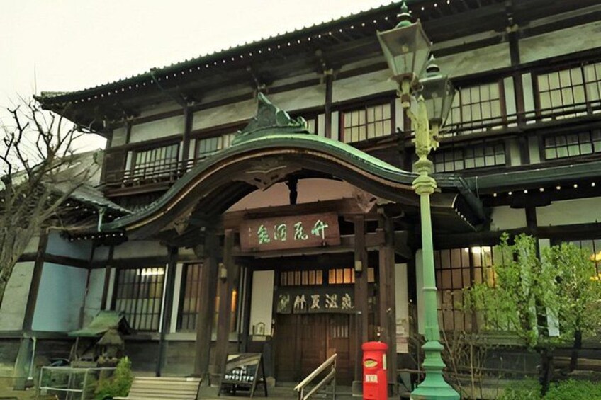 A traditional Japanese building with a curved roof and wooden structure. 5