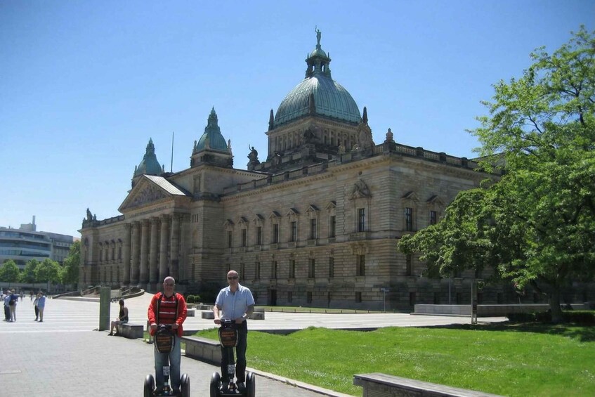 A large historic building with domed architecture and a paved walkway. 5