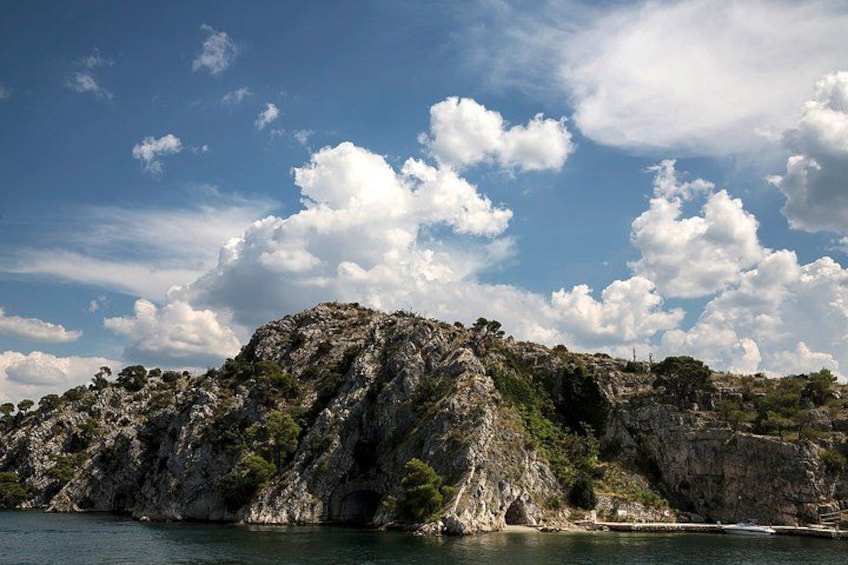 A rocky coastline with a clear sky and scattered clouds. 4