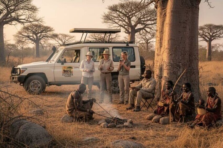 A safari vehicle with people around a campfire in a savanna landscape. 2