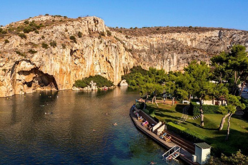 A river with a boat, a rocky cliff, and a park with trees. 3