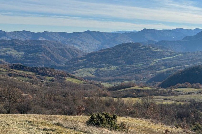 A mountainous landscape with rolling hills and a valley. 1