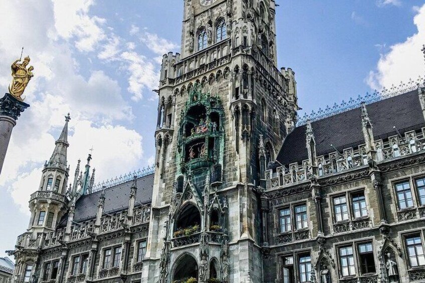 A historic building with intricate architecture, including a prominent tower and ornate windows. 4