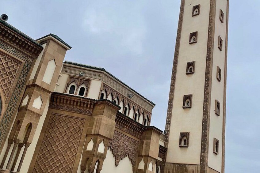 Un edificio storico caratterizzato da archi elaborati e un'alta torre. 4