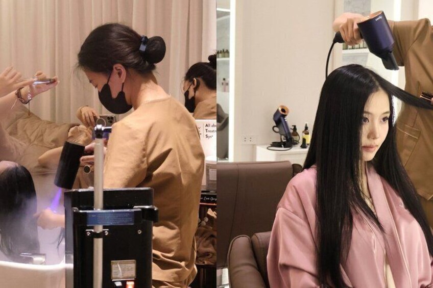 A salon with a hairdryer and a hair straightener on a table. 1