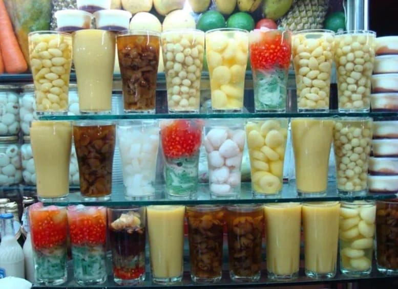 A variety of colorful beverages in glass containers on a shelf. 5