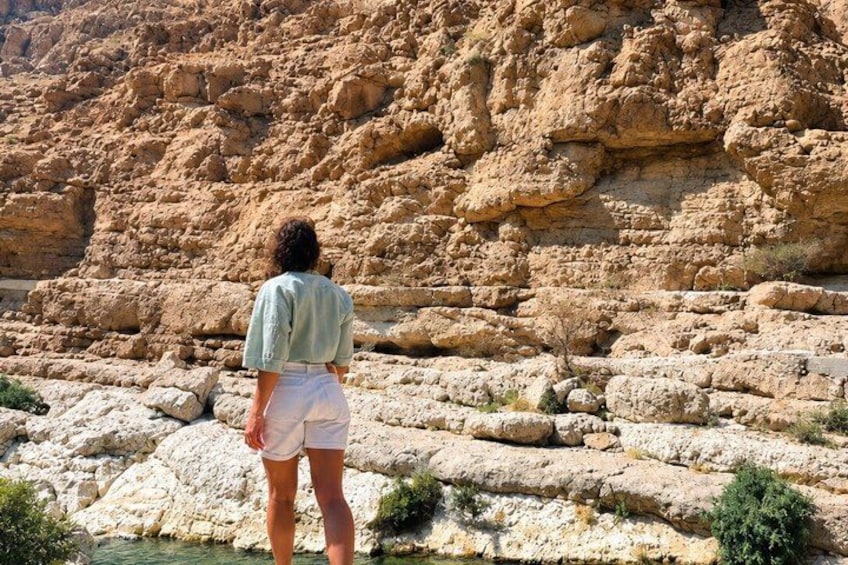 A person standing in front of a rocky landscape with a clear view of the terrain. 1