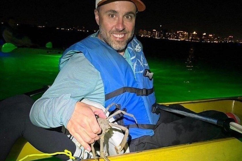Una persona en un kayak amarillo, con chaleco salvavidas azul y sosteniendo un remo. 5