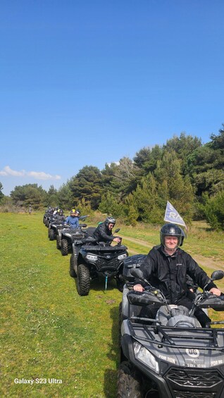 A line of Galaxy S23 Ultra ATVs on a grassy field with trees in the background. 2