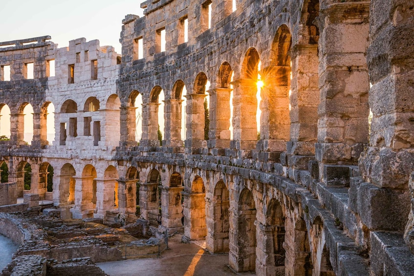 Ancient stone ruins with arches and columns, bathed in warm sunlight. 3
