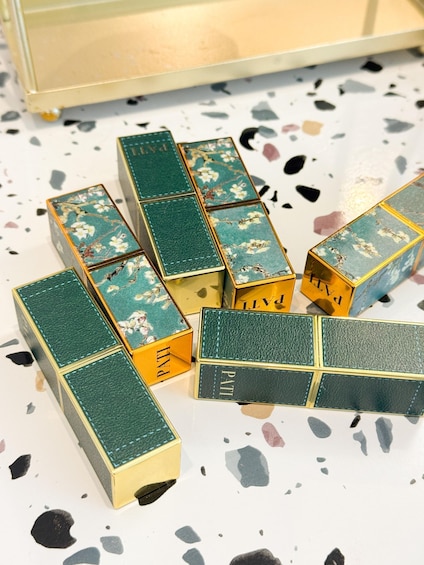 A collection of jewelry boxes with floral designs and the word 'PAT' on them. 3