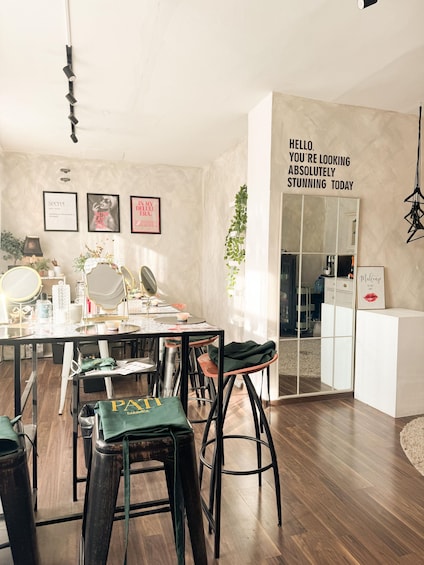 A modern interior with a dining area, bar stools, a mirror, and decorative items. 2