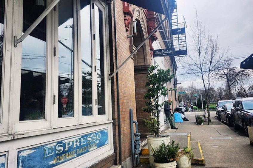 A storefront with a sign for 'ESPRESSO' and a brick building with a fire escape. 5
