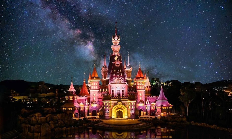 A castle illuminated at night with a starry sky. 2