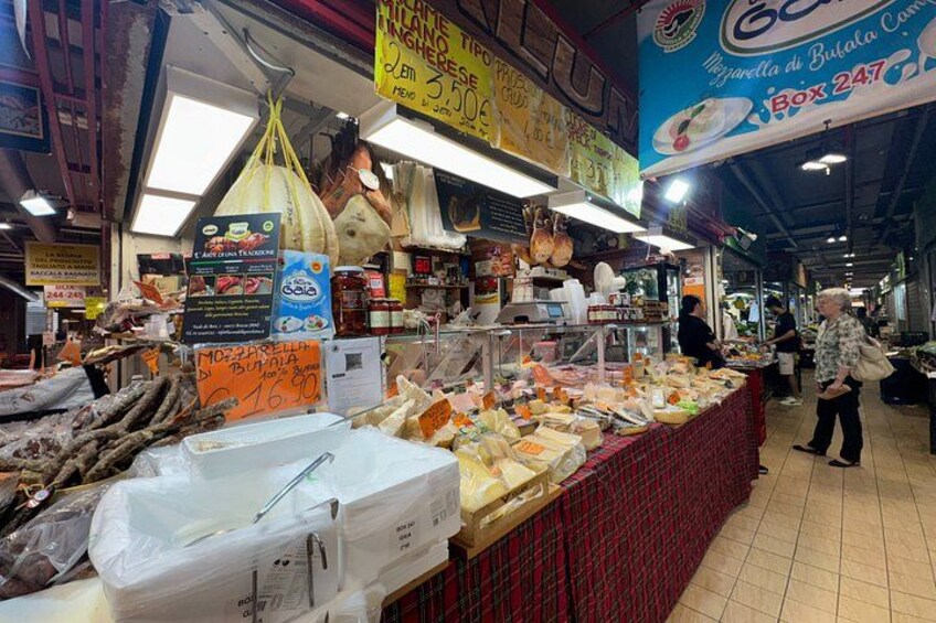A market stall with various food items, including packaged goods and fresh produce. 2