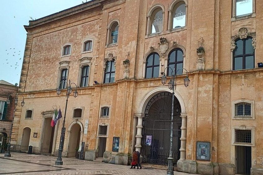 A historic building with arched windows and a large entrance. 3
