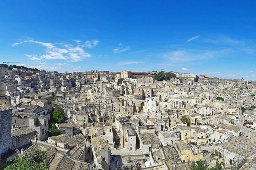 A densely packed urban landscape with historic buildings and a prominent church tower. 5