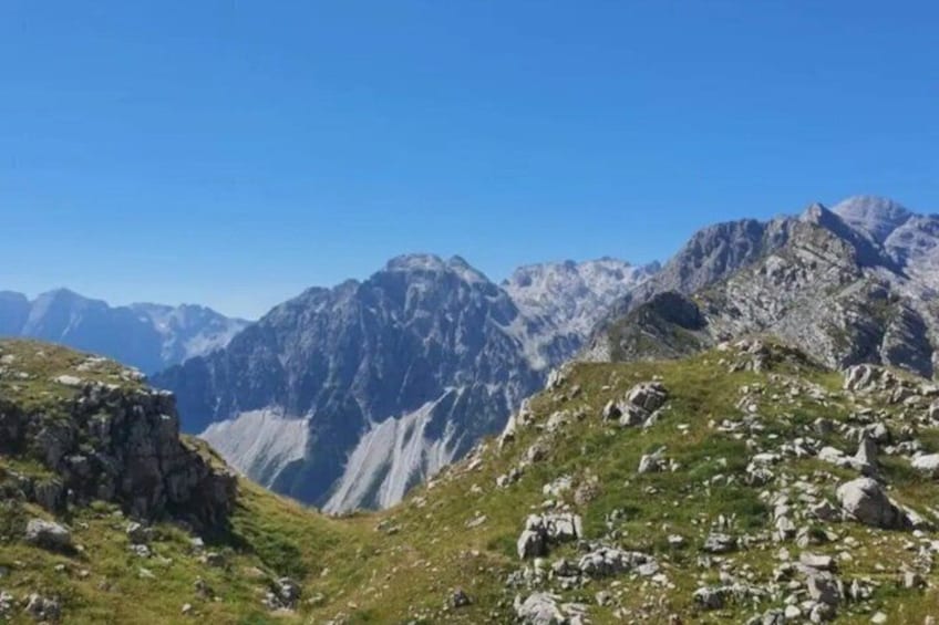 A mountainous landscape with rocky terrain and grassy areas. 3