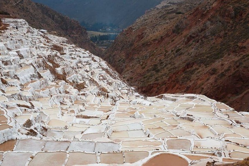 Terraced salt flats with a valley in the background. 1